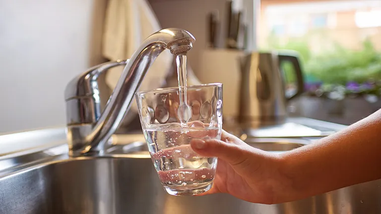Clean water into cup from sink